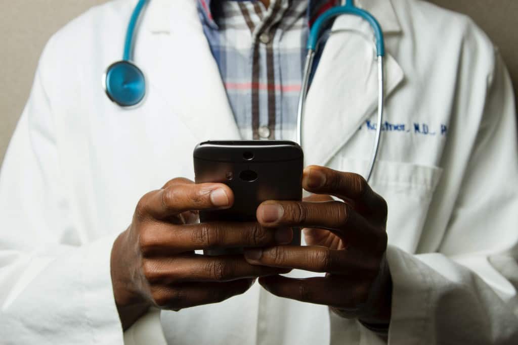 Image of doctor using a phone for care