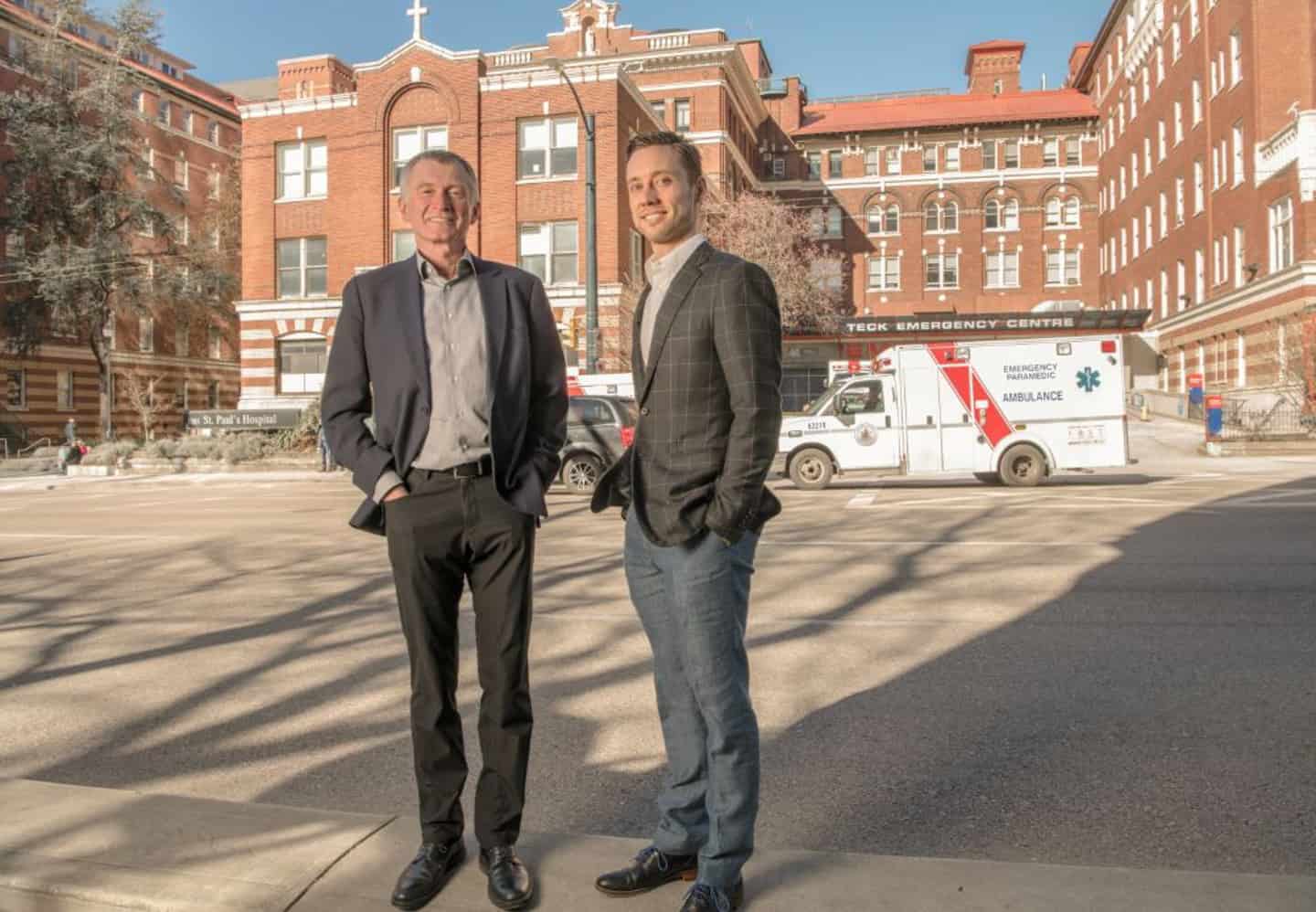 Image of Drs. Jim Christenson and Brian Grunau stand outside of Teck Emergency Centre at St. Paul's Hospital.