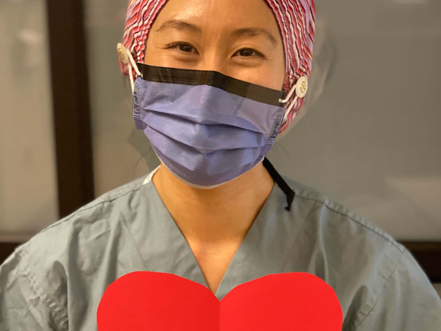 Nurse holding a paper heart.