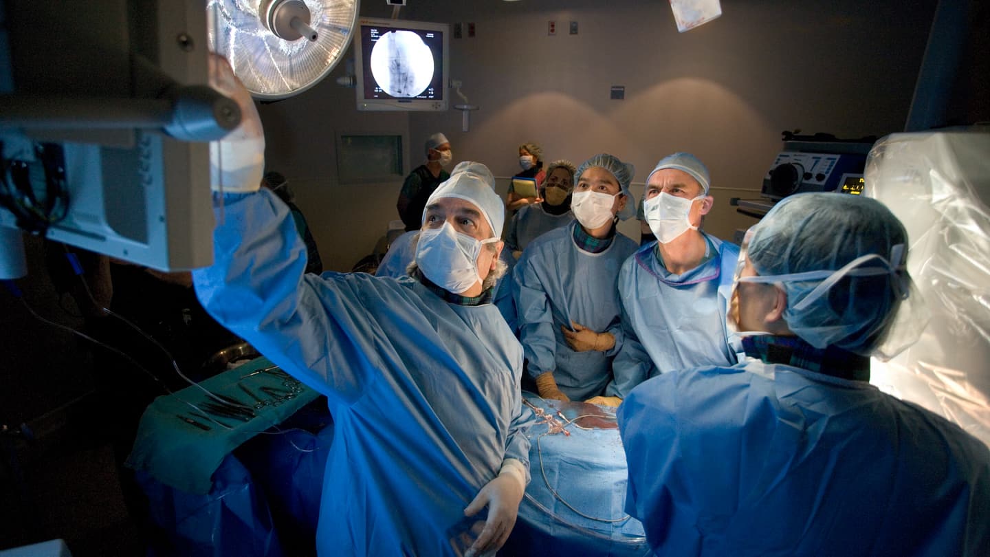 Drs. Samuel Lichtenstein, Anson Cheung, and John Webb performing surgery.
