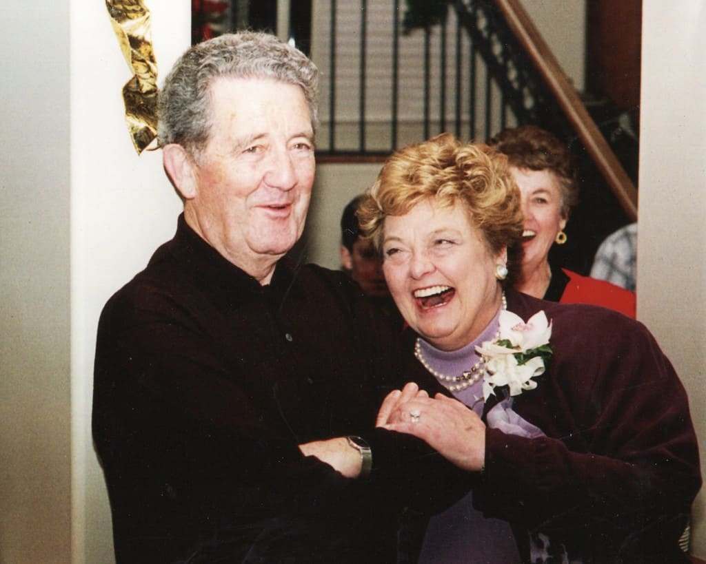 Image of Jack and Pat O'Neill linking arms and laughing
