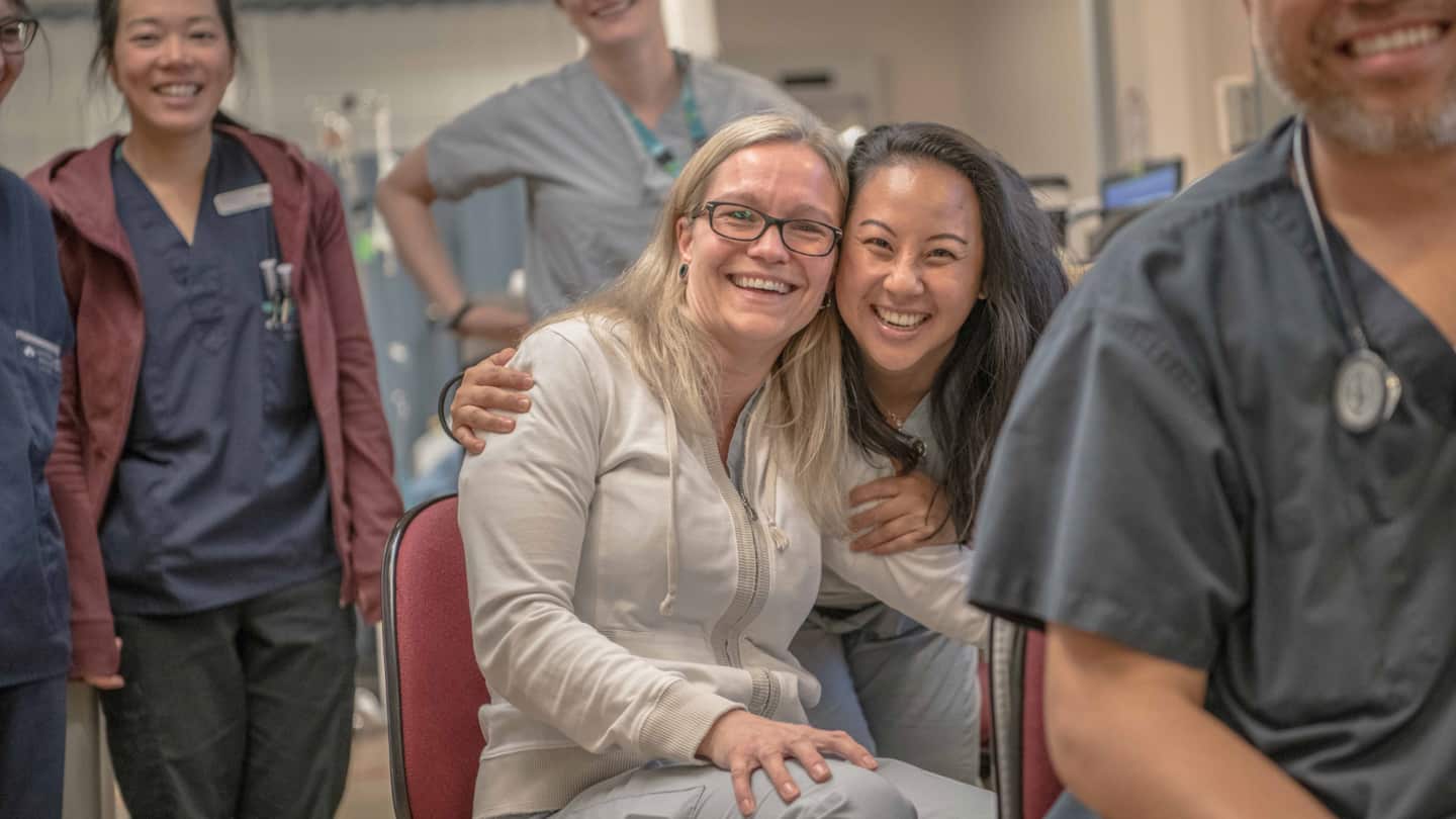 Two caregivers smiling.