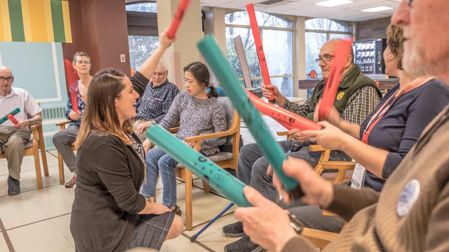 A group of residents participate in music therapy at Youville.