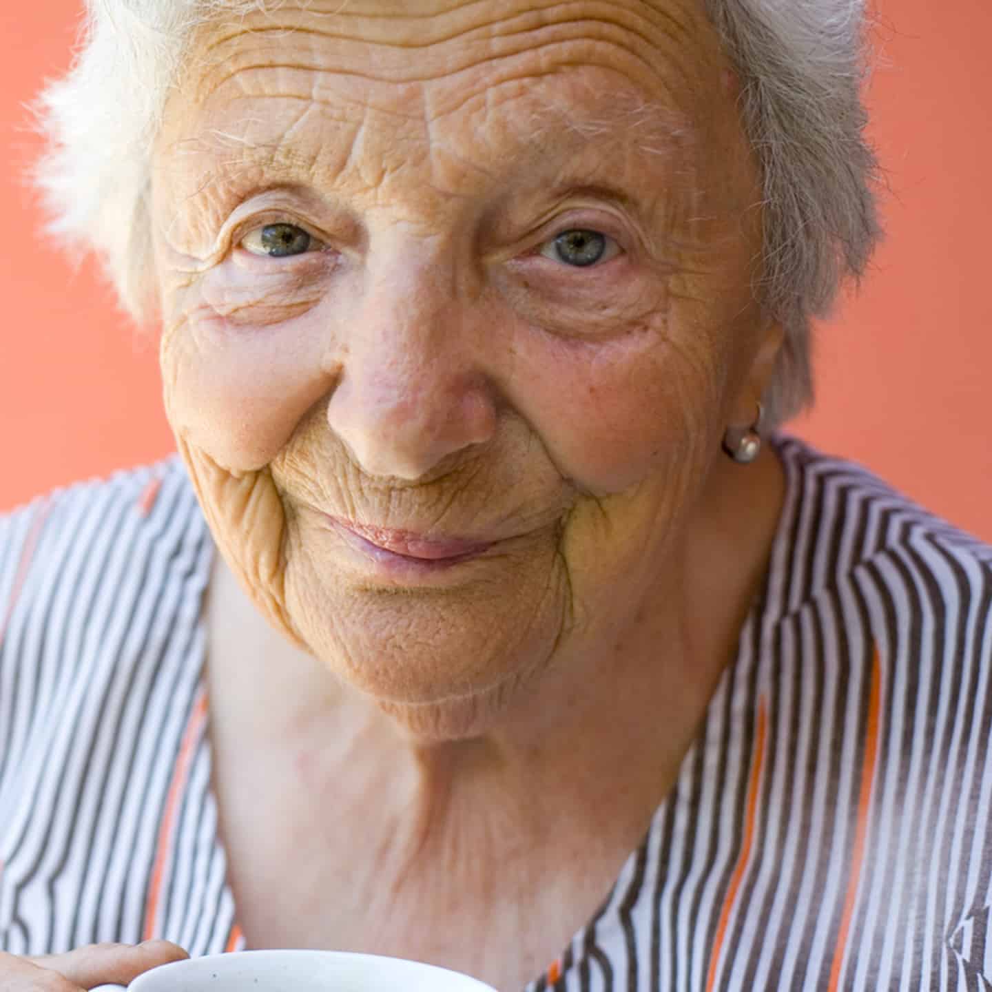 An elderly woman looking at camera.