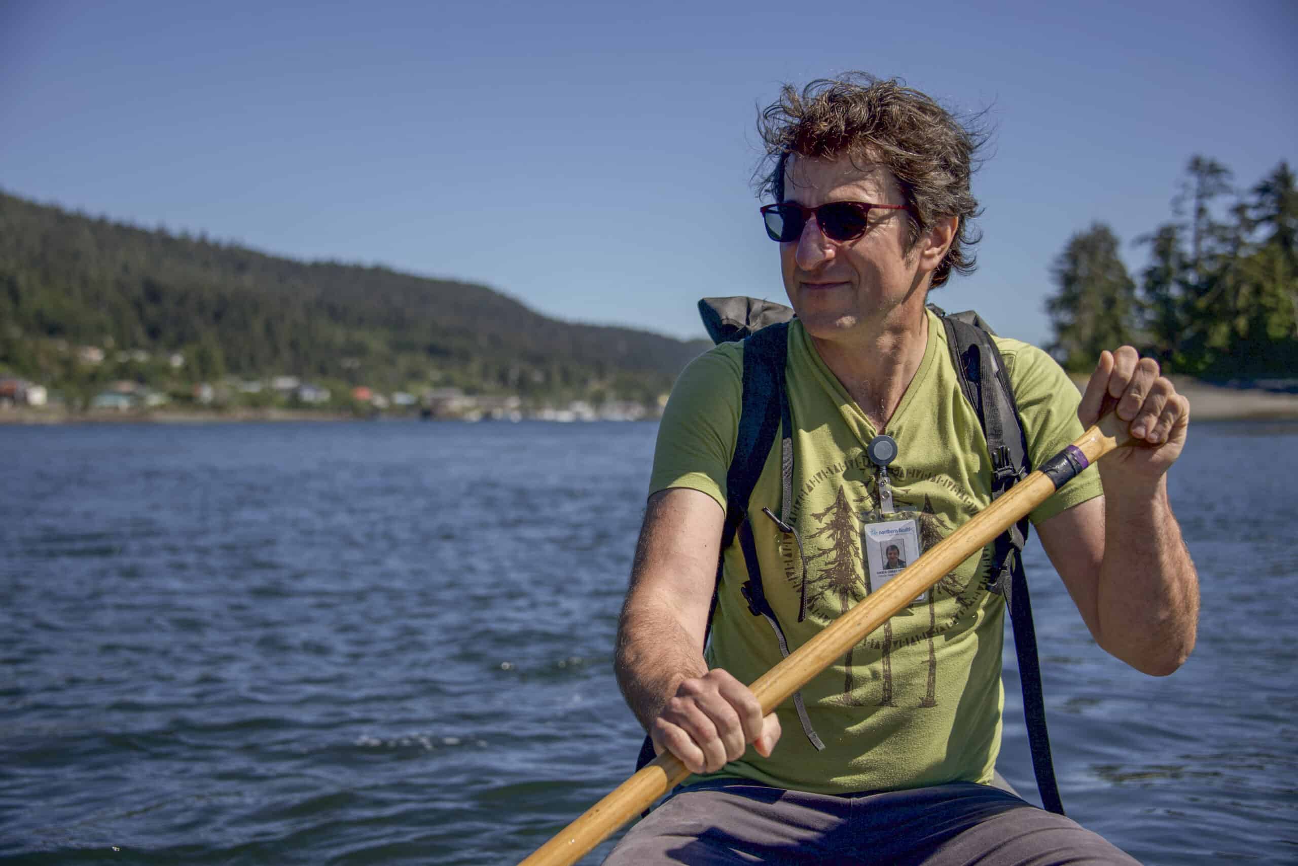 Photo of Dr. Tracy Morton in a kayak with a paddle, on a sunny day.