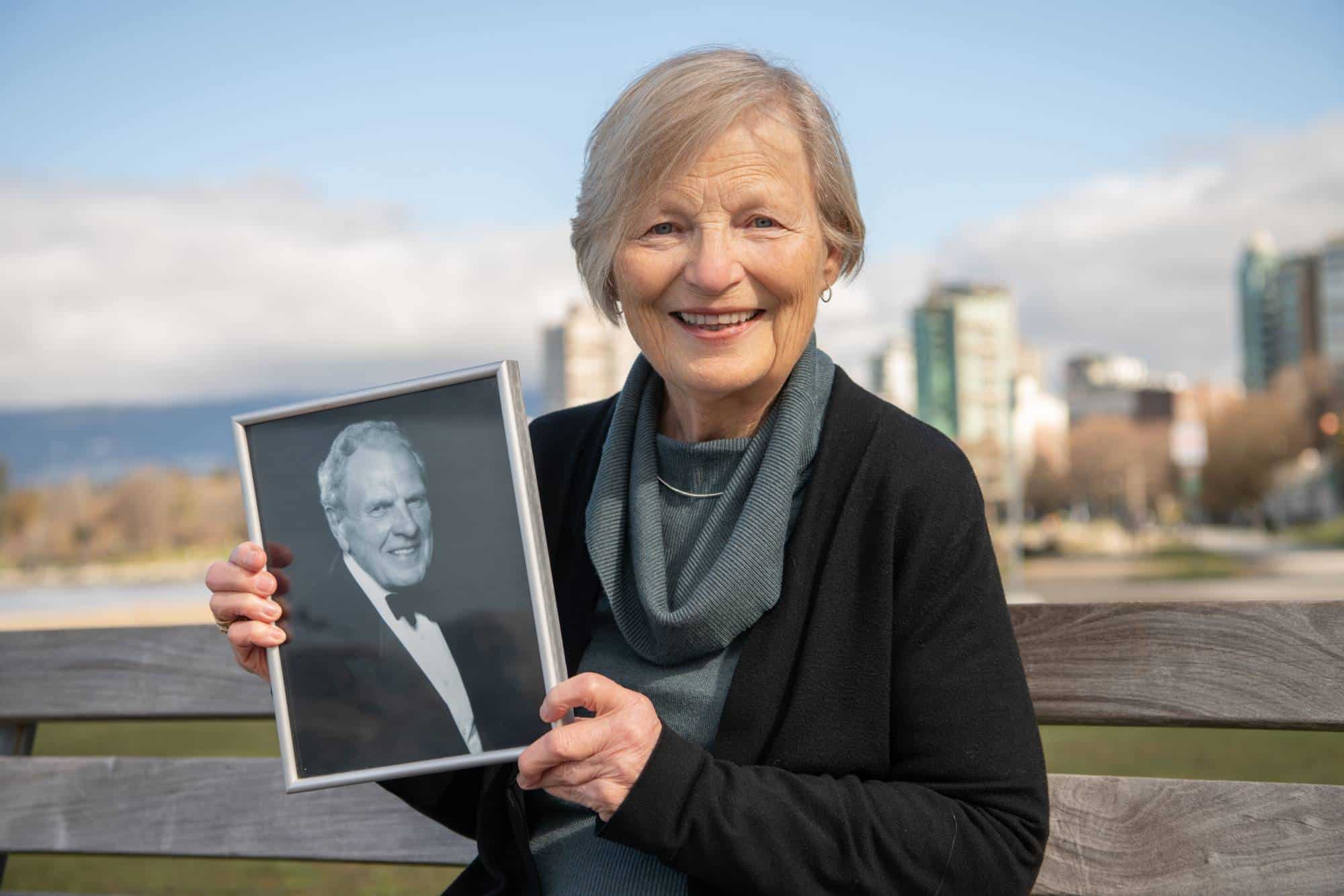 Frances holding a picture of her late husband while describing the early intervention memory clinic