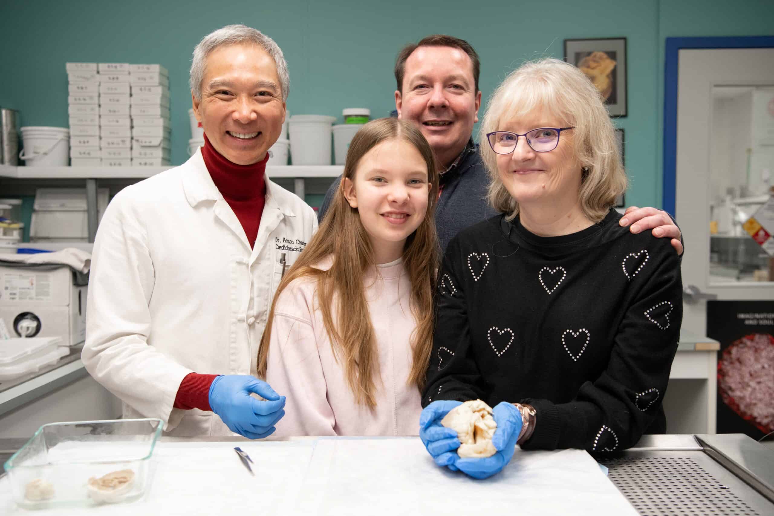 Dr. Cheung, Christine’s daughter, Christine’s husband, and Christine holding her old heart.