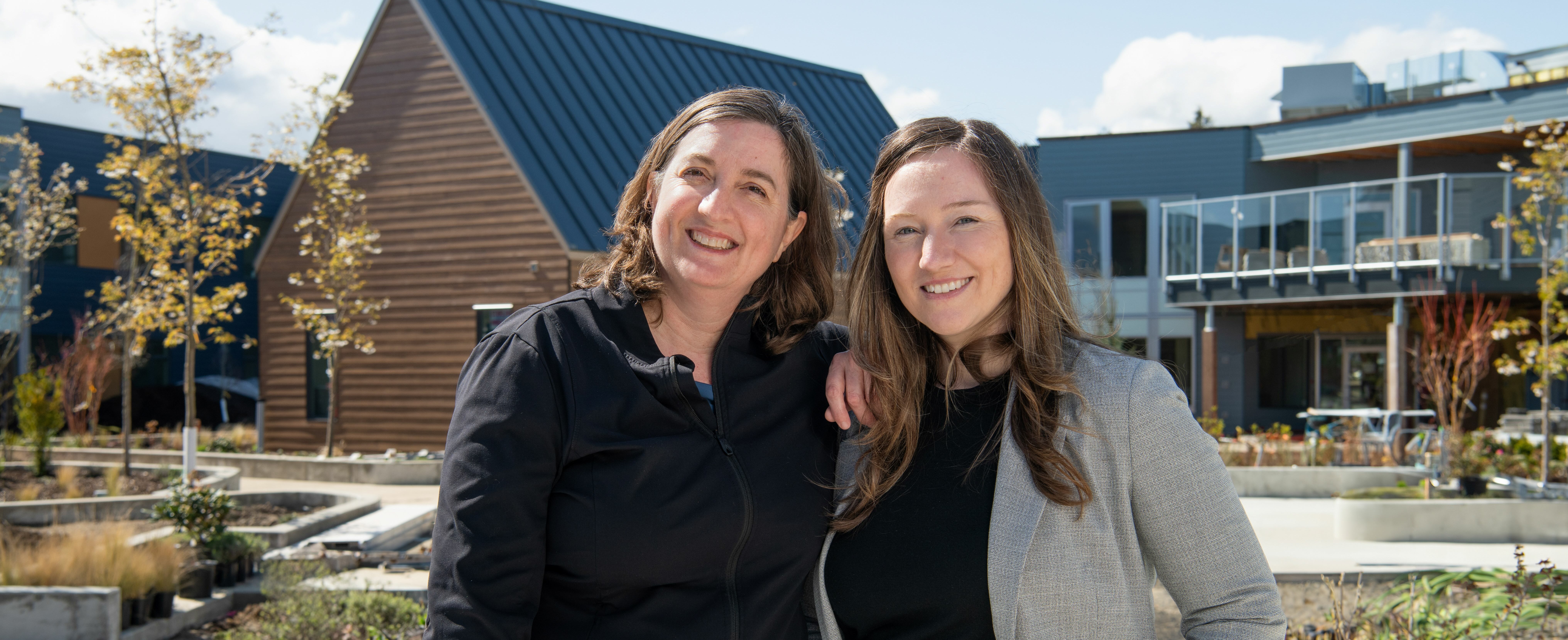 Joyce Shepherd, recreation therapist, Providence Living, and Dr. Jennifer Gibson, director of Quality, Practice, and Program Development, Providence Living, standing in the courtyard of The Views.