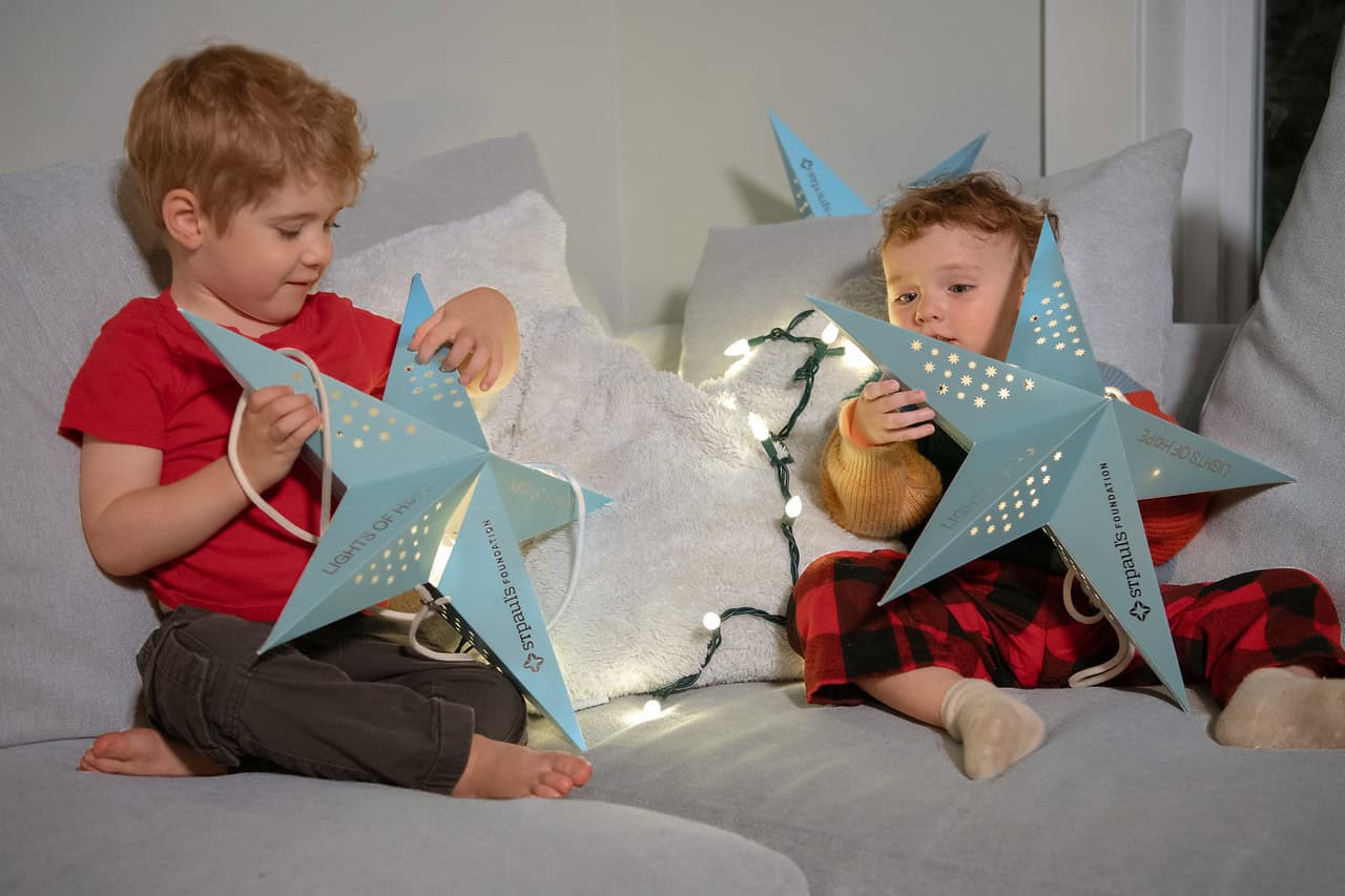 2 children holding hope at home lanterns