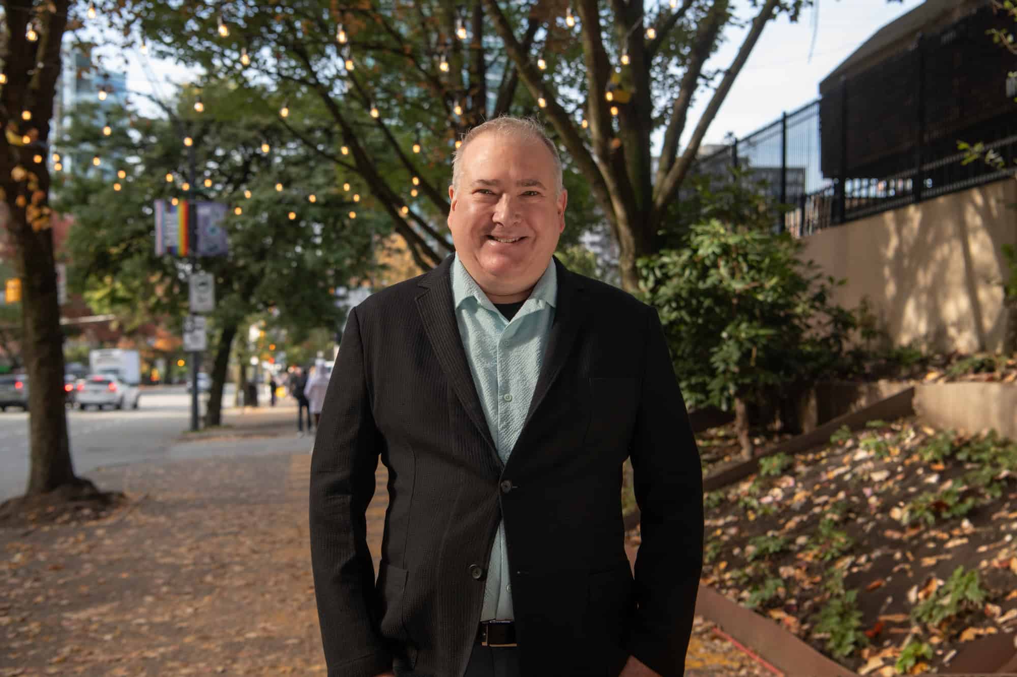 George standing in front of St. Paul's Hospital.