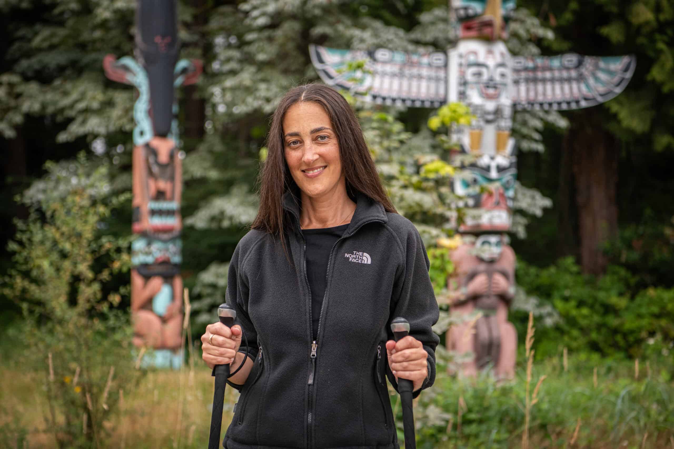 Karam in front of the Stanley Park totem poles.