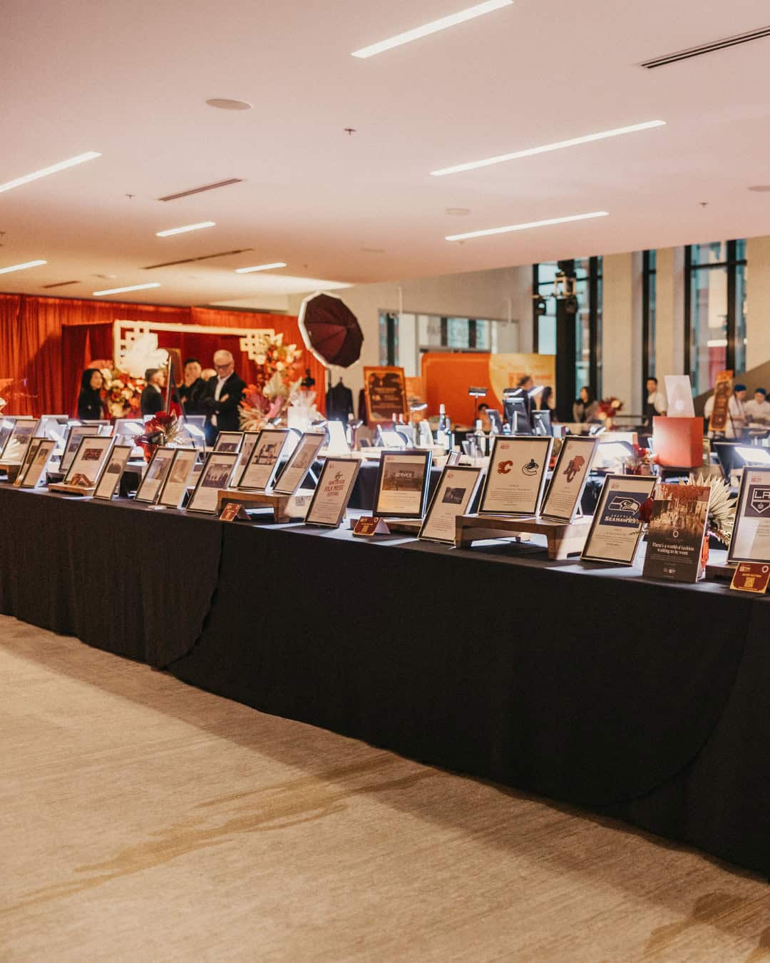 Photo of the silent auction table at the 2024 Feast of Fortune gala