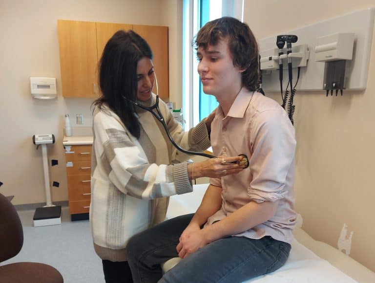 Dr. Jasmine Grewal examines Sam Bennison at the new Prince George VPACH partnership clinic.