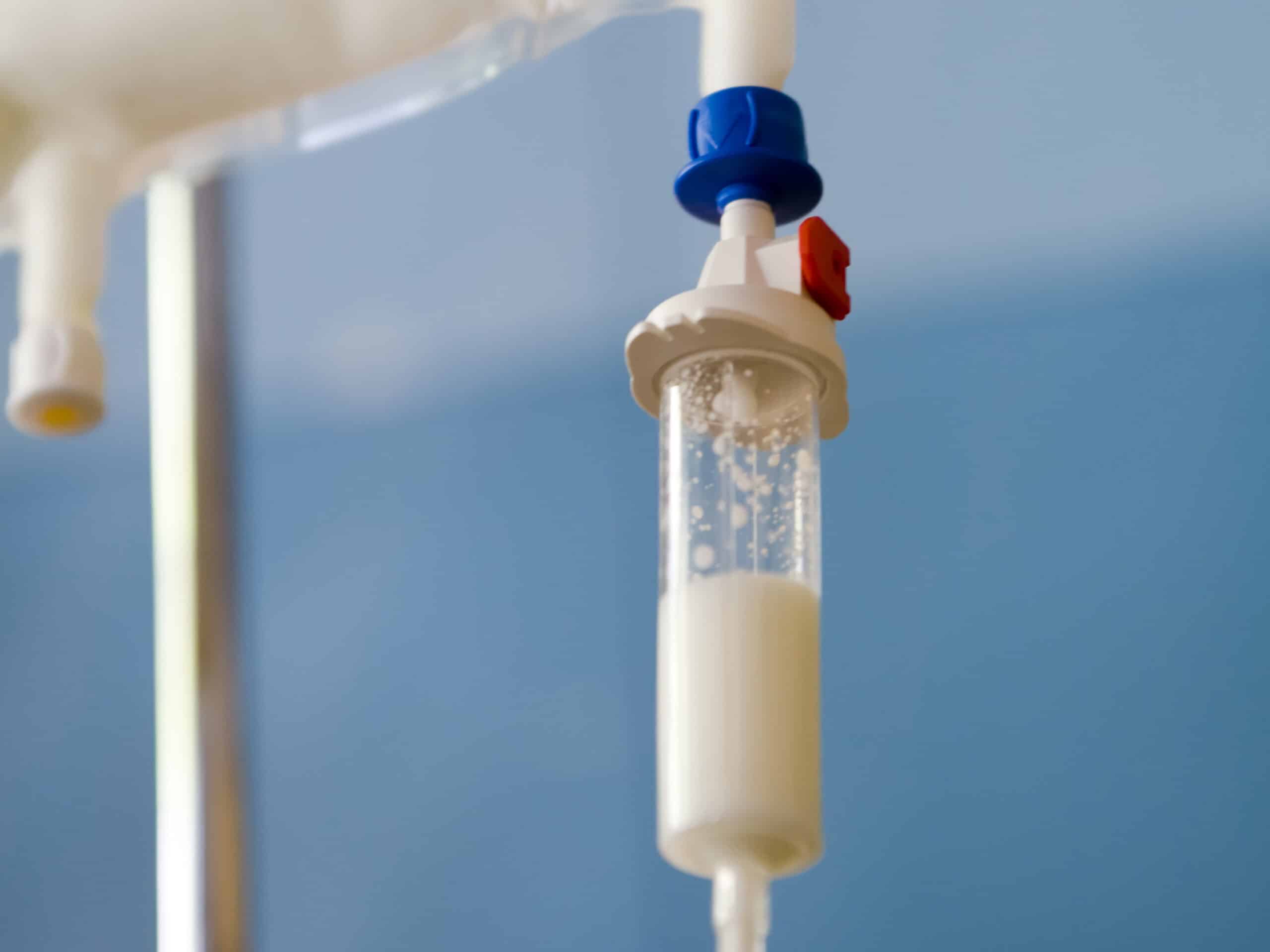 Photo of an IV drip filled with white substance.