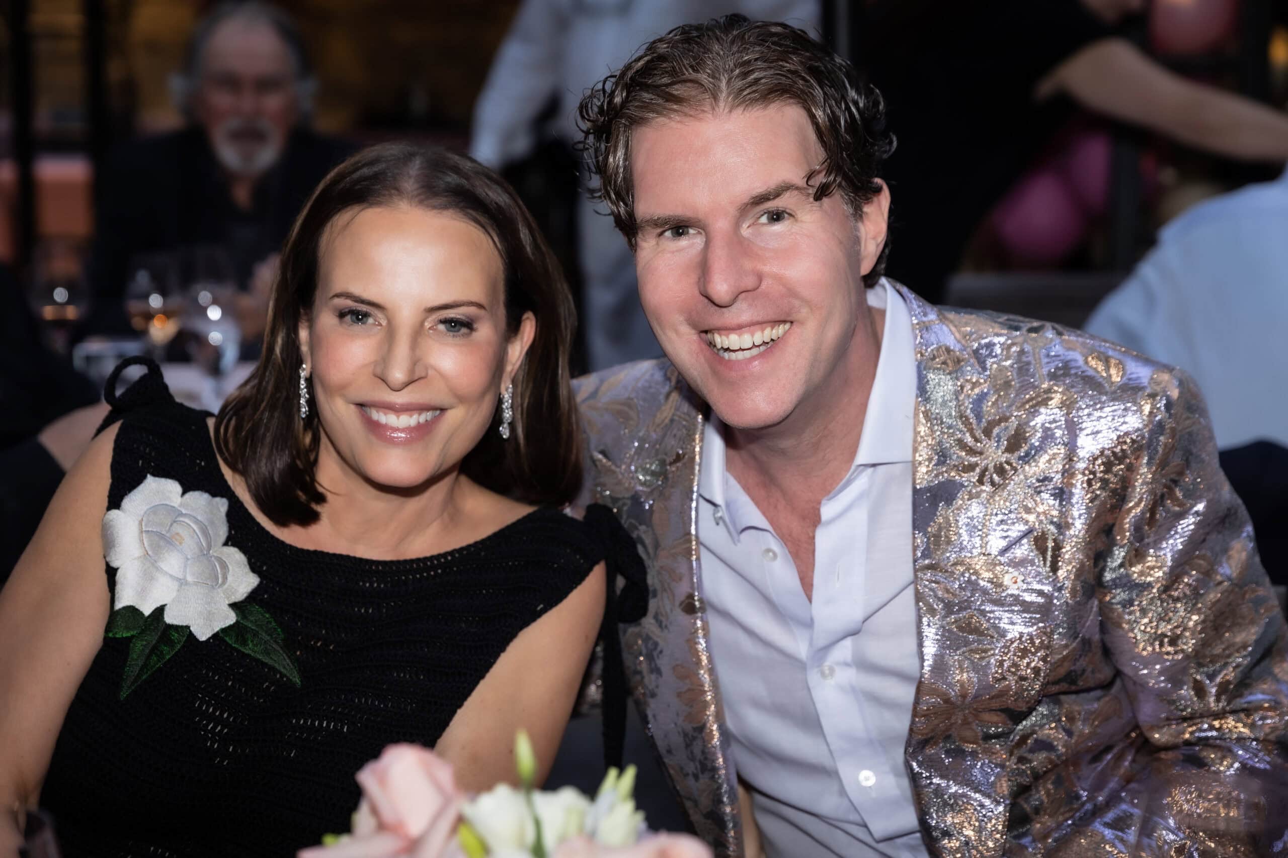 Cindy and Ryan Beedie are seated and smiling at the camera.